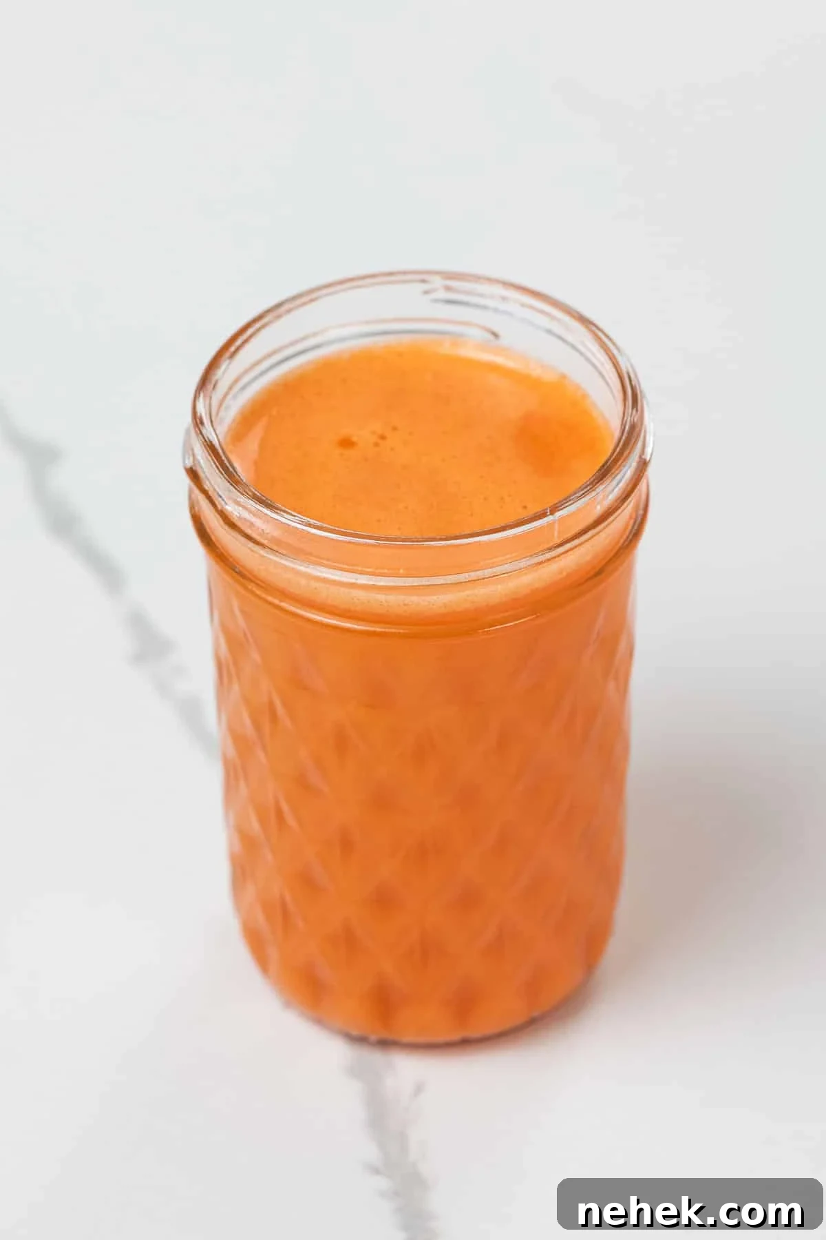 sweet potato, carrot, and orange juice in a small glass