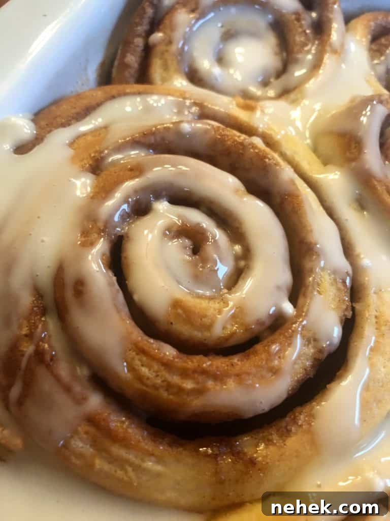 A cinnamon roll topped with icing.