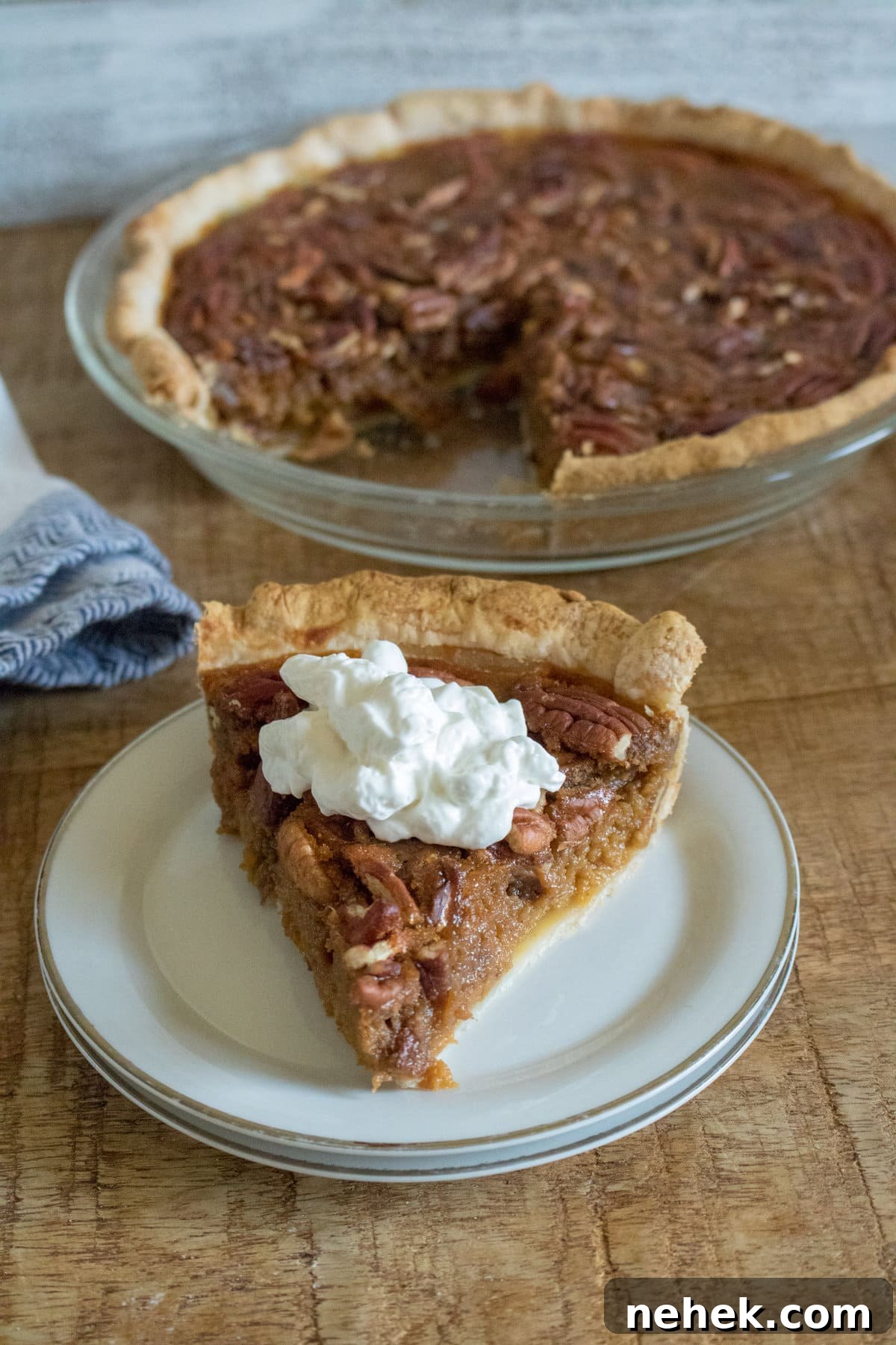 Pumpkin pecan pie on a round plate.