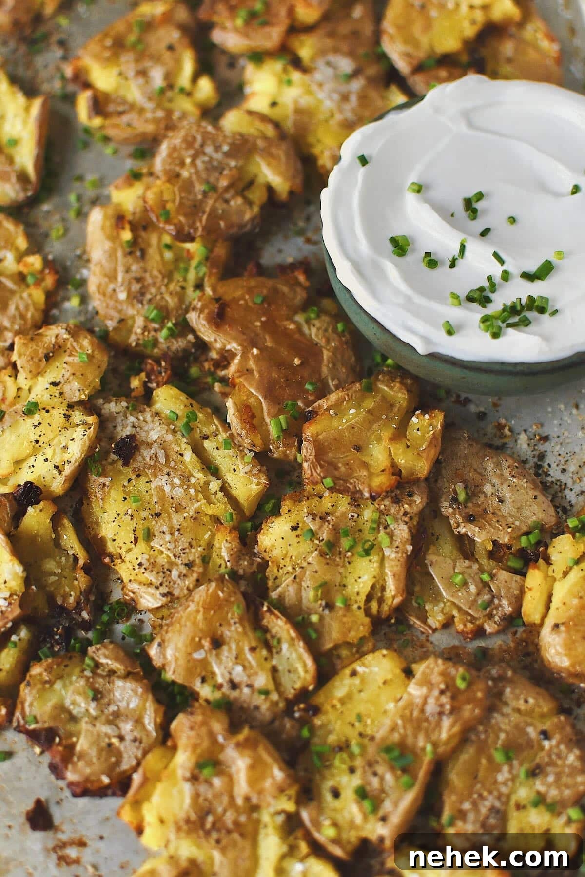 Crispy Smashed Potatoes with Garlic and Herbs 11 Crispy Smashed Potatoes just out of the oven ready to be enjoyed with some chive sour cream on the side.