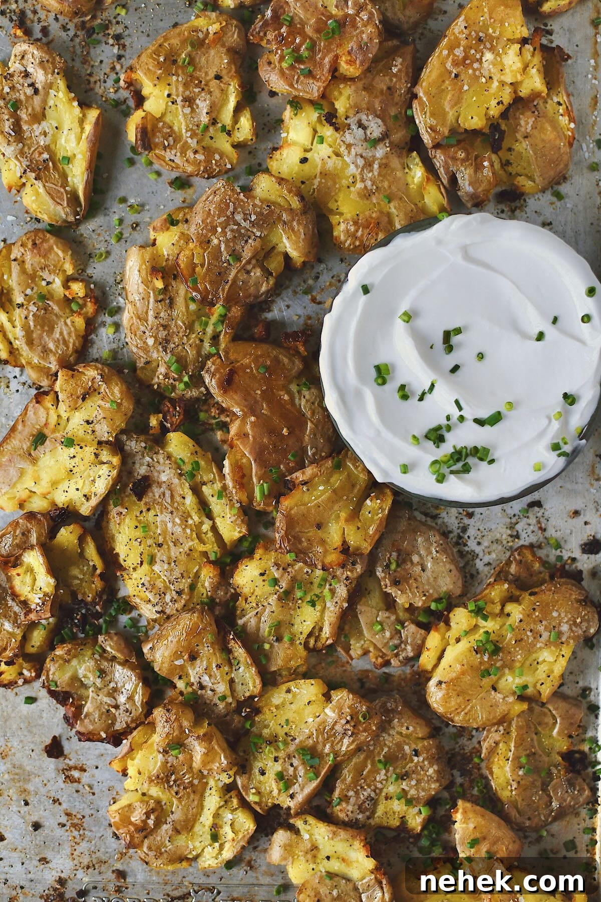 Crispy Smashed Potatoes with Garlic and Herbs 10 Crispy Smashed Potatoes just out of the oven ready to be enjoyed with some chive sour cream on the side.