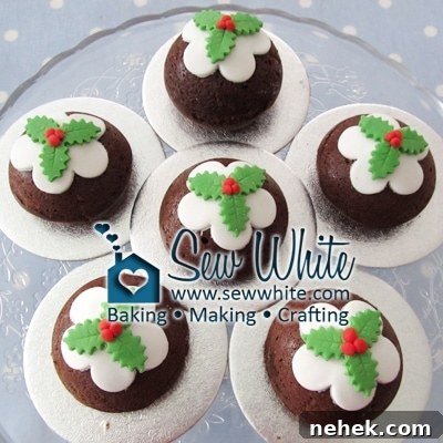 little Christmas Pudding Cakes topped with white icing and cut out holly leaves