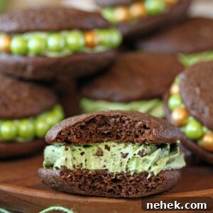 Close up of Mint Chocolate Chip Whoopie Pies on a wooden surface.
