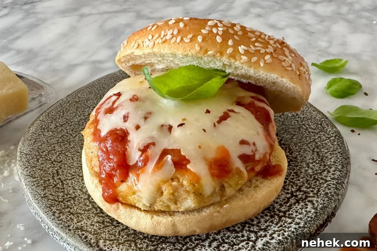 Chicken Parmesan Burger Recipe: Crispy, Cheesy Sandwiches 2 Chicken Parmesan Burgers on a plate.