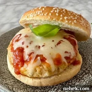 Chicken Parmesan Burger Recipe: Crispy, Cheesy Sandwiches 13 Chicken Parmesan Burgers on a plate.