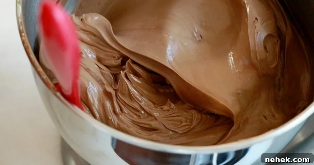 Classic Moist Chocolate Cake Recipe for Crowning Any Occasion 10 silky chocolate buttercream in a bowl