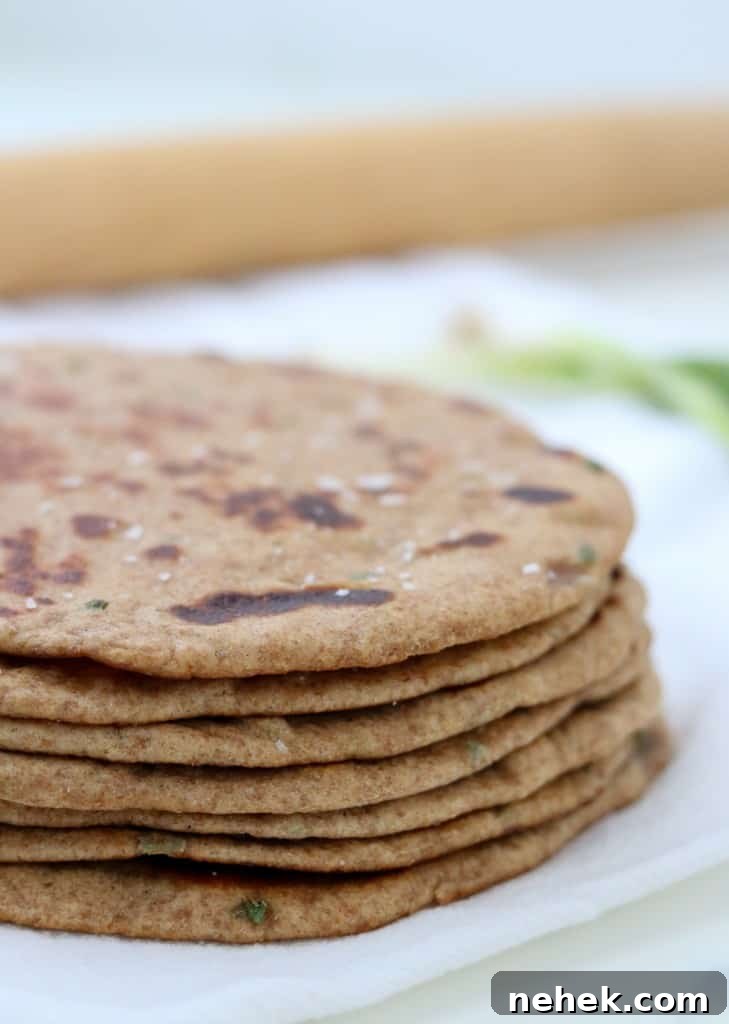 Close up of stack of flatbreads with a rolling pin