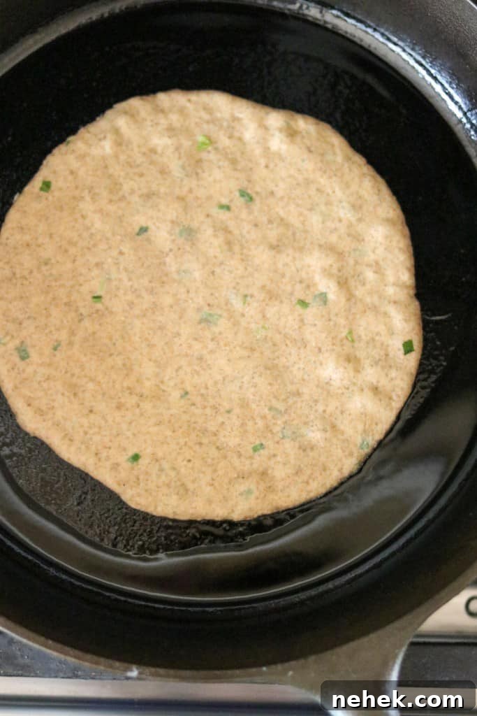 flatbread cooking in a cast iron skillet