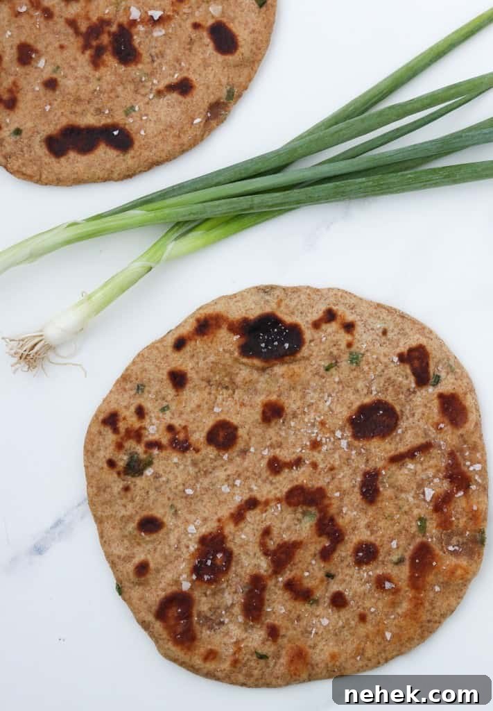 Flatbreads on a countertop with scallions