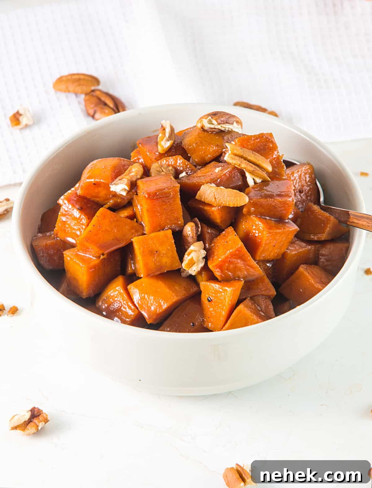 a bowl of candied sweet potatoes with nuts 