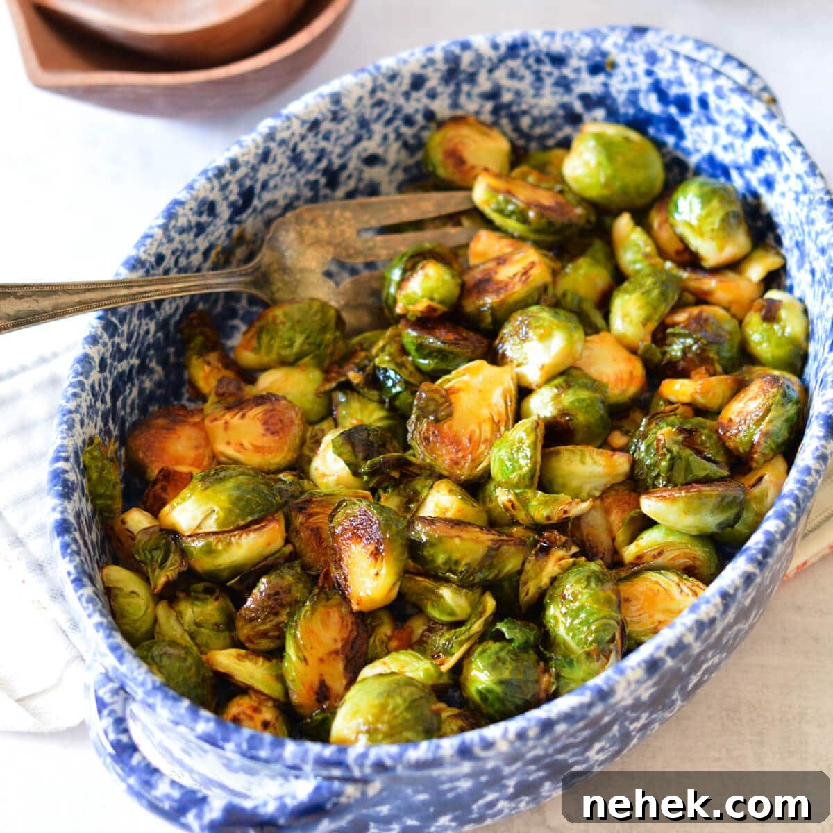 a serving dish with brussels sprouts in it.