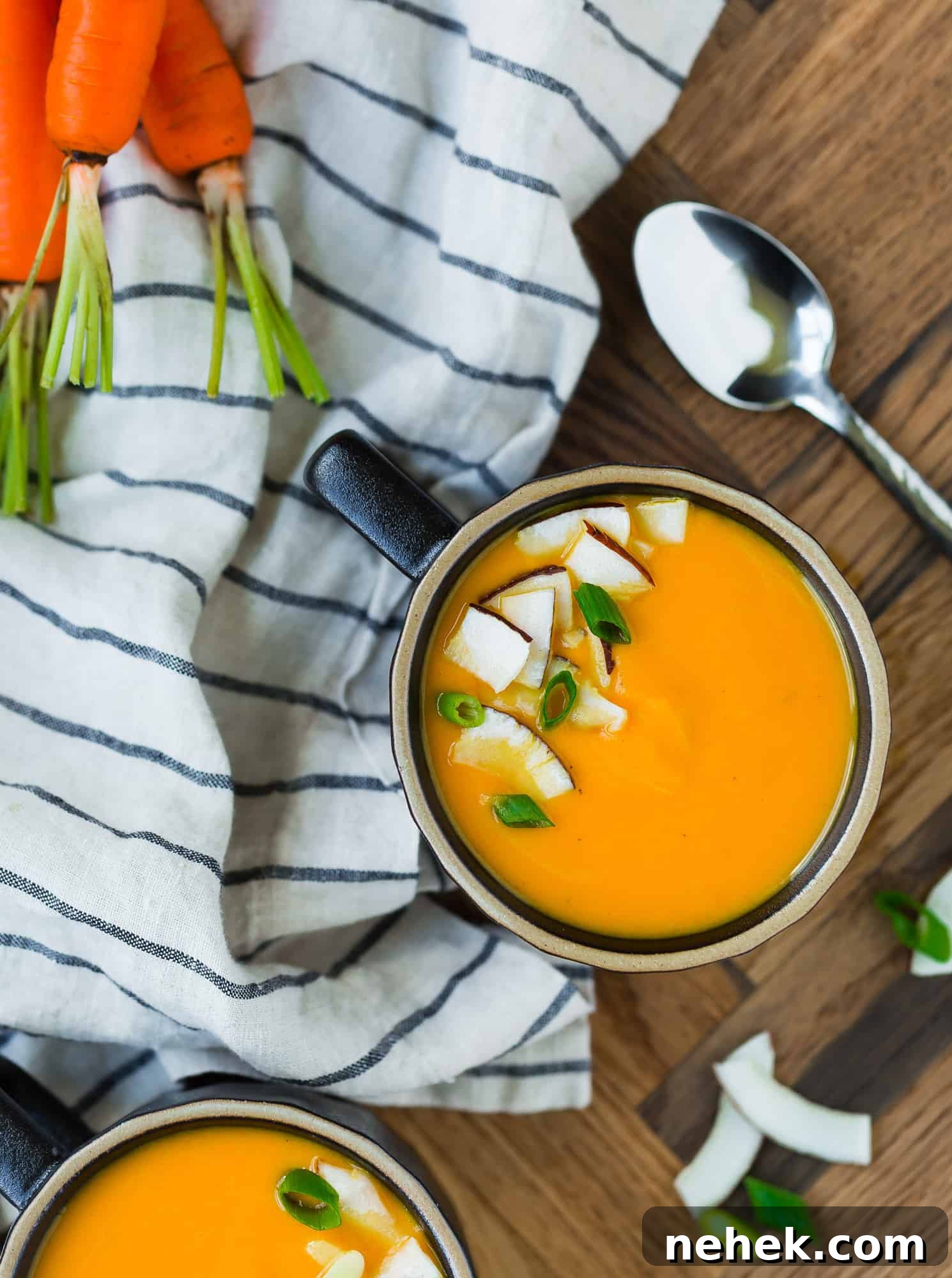 Vibrant Carrot Ginger Soup — Vegan & Whole30-Friendly Recipe 3 Overhead view of carrot ginger soup garnished with coconut.