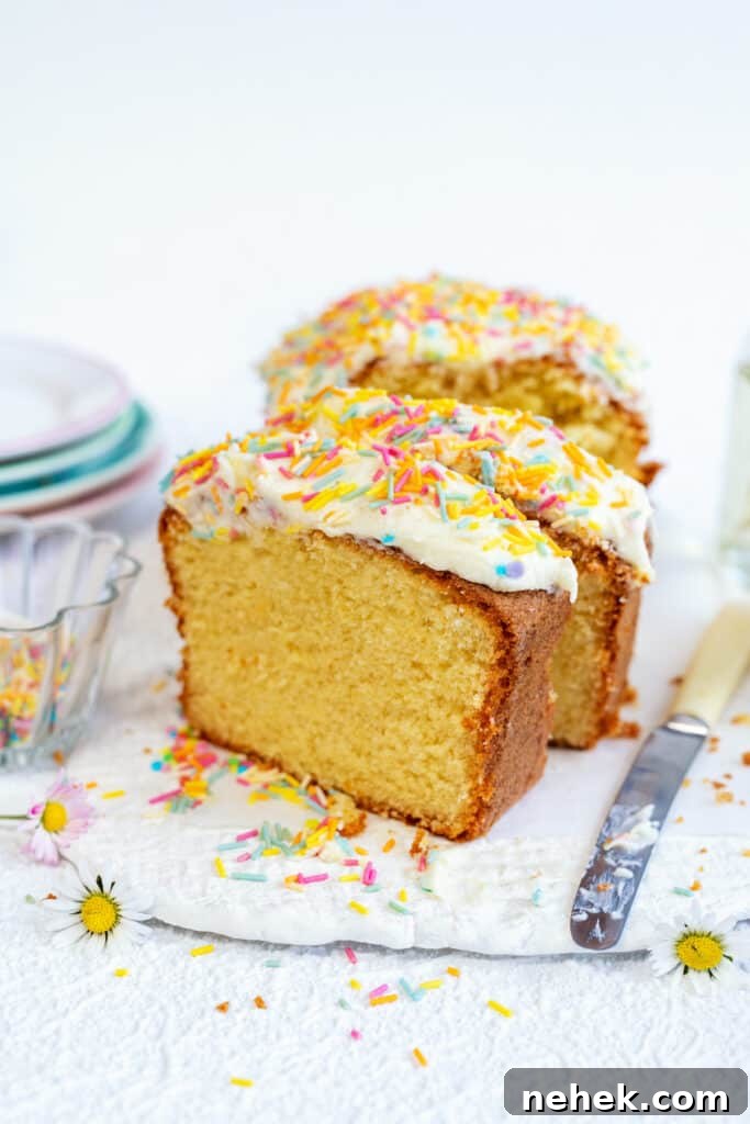 Classic Vanilla Loaf Cake Recipe with Moist, Tender Crumb 3 Slices of frosted vanilla cake on a ceramic board