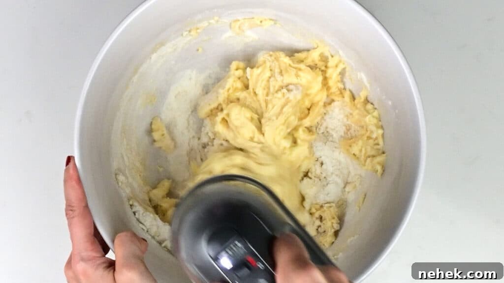 Classic Vanilla Loaf Cake Recipe with Moist, Tender Crumb 5 Beating cake batter with an electric mixer