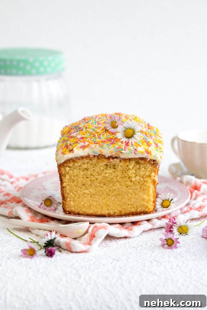 Classic Vanilla Loaf Cake Recipe with Moist, Tender Crumb 6 Simple vanilla pound cake topped with buttercream and sprinkles on a plate