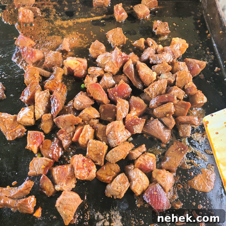 Teriyaki Steak Fried Rice starting to cook on Blackstone griddle. 