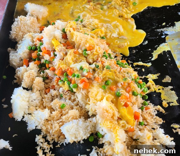 Teriyaki Steak Fried Rice cooking on blackstone griddle all mixed together 