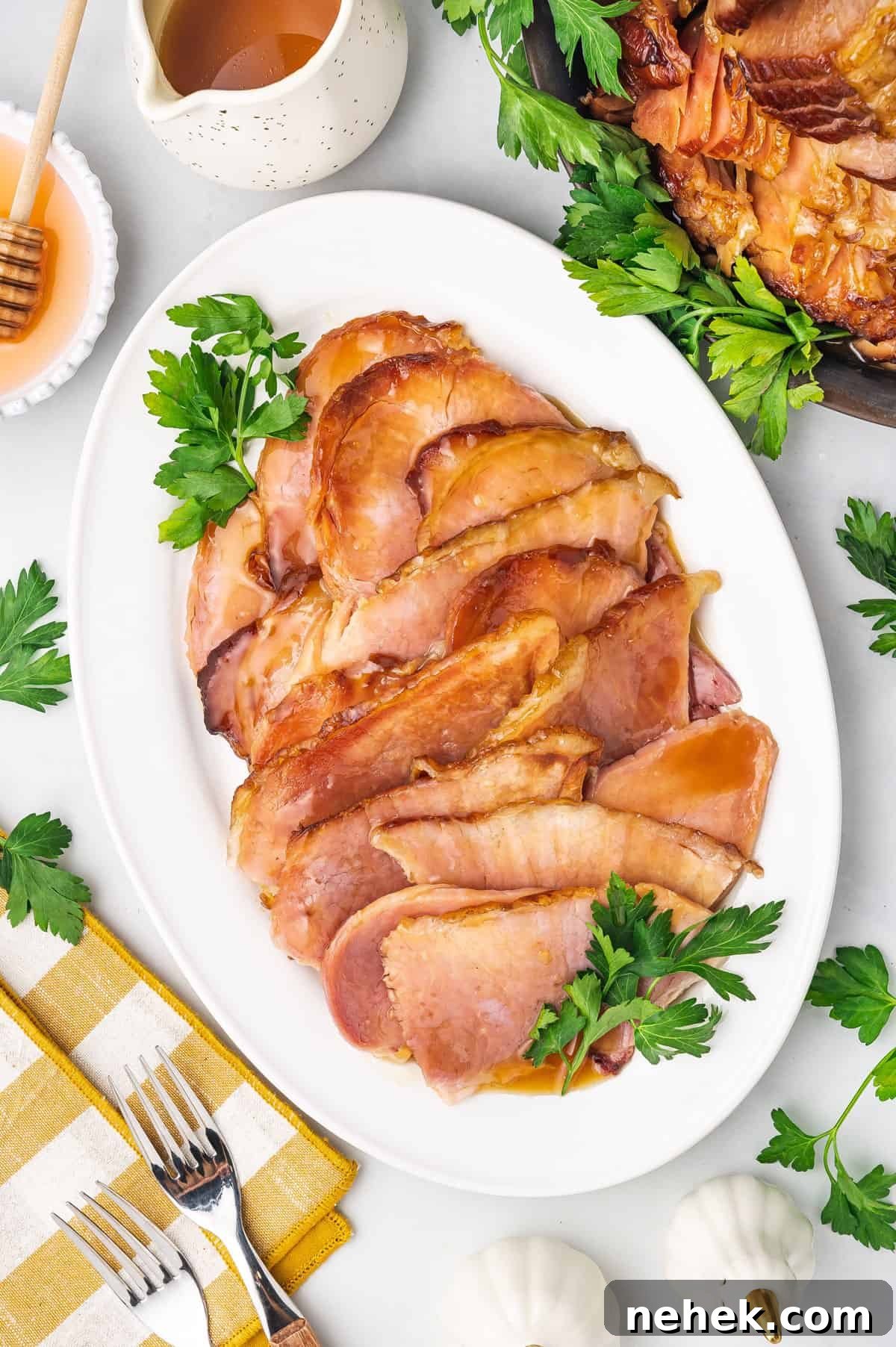 Slow Cooker Honey-Glazed Ham Recipe for Tender, Juicy Results 6 Overhead view of sliced slow cooker ham on a platter.