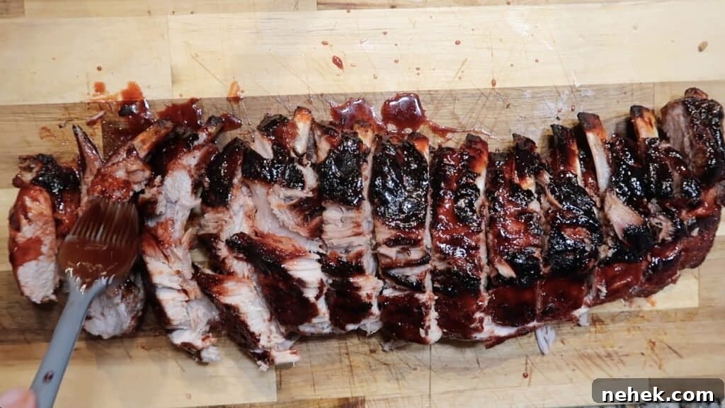 Brushing char siu sauce onto sliced ribs