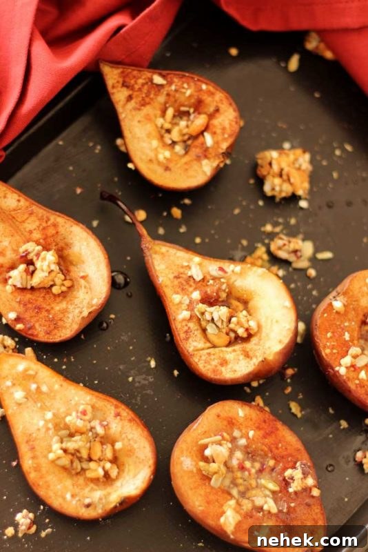 Maple Vanilla Baked Pears with Crunchy Granola Topping 8 Brown flexipan containing 6 baked pears topped with granola, red napkin around pan.