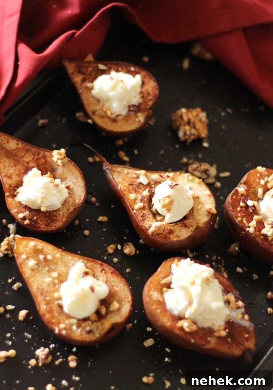 Maple Vanilla Baked Pears with Crunchy Granola Topping 9 Brown flexipan containing 6 baked pears topped with granola and ice cream, red napkin around pan.