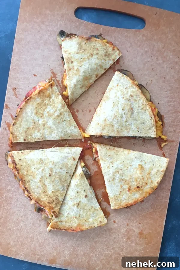 overhead view of quesadilla on a cutting board, cut into 6 triangles