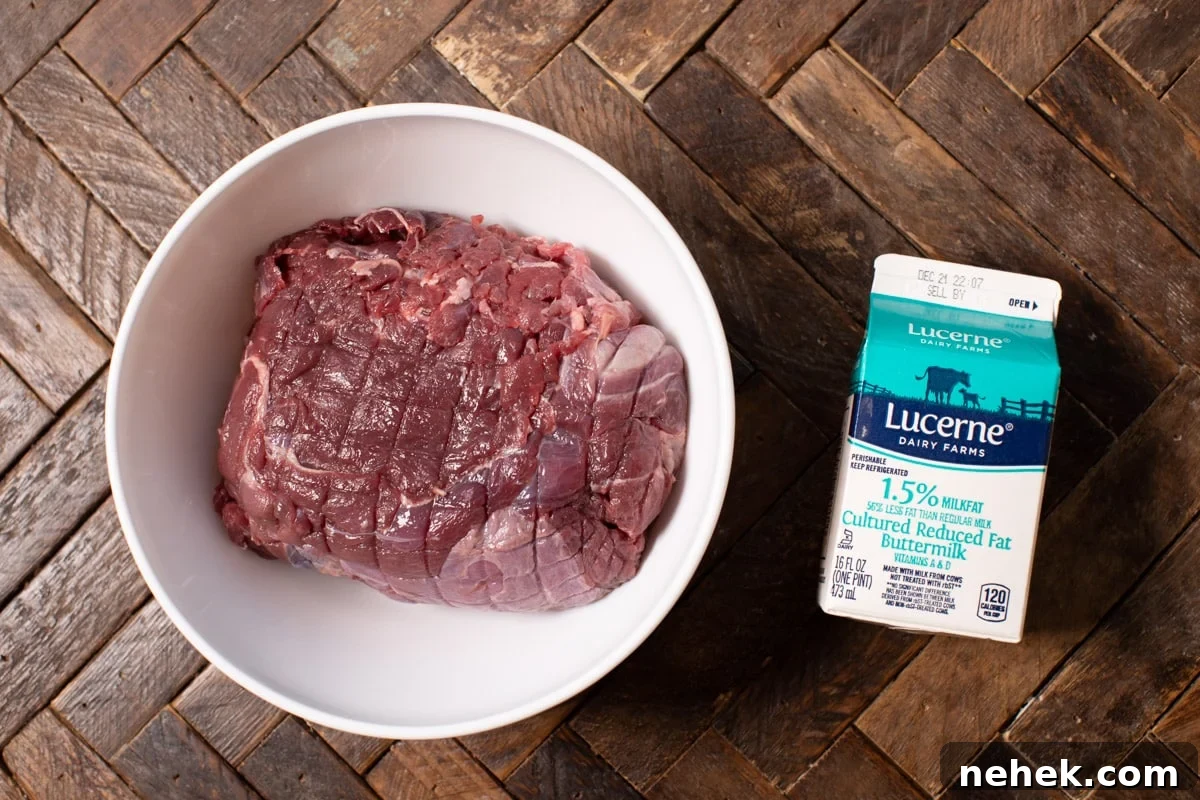 Slow-Cooked Venison Roast with Savory Mushroom Gravy 4 venison roast in bowl and carton of buttermilk next to it.