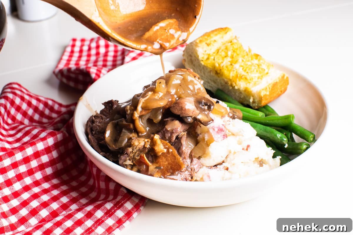 Slow-Cooked Venison Roast with Savory Mushroom Gravy 8 gravy being poured over venison roast
