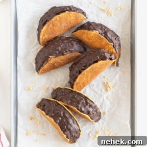 Six choco tacos on a parchment lined aluminum baking sheet.