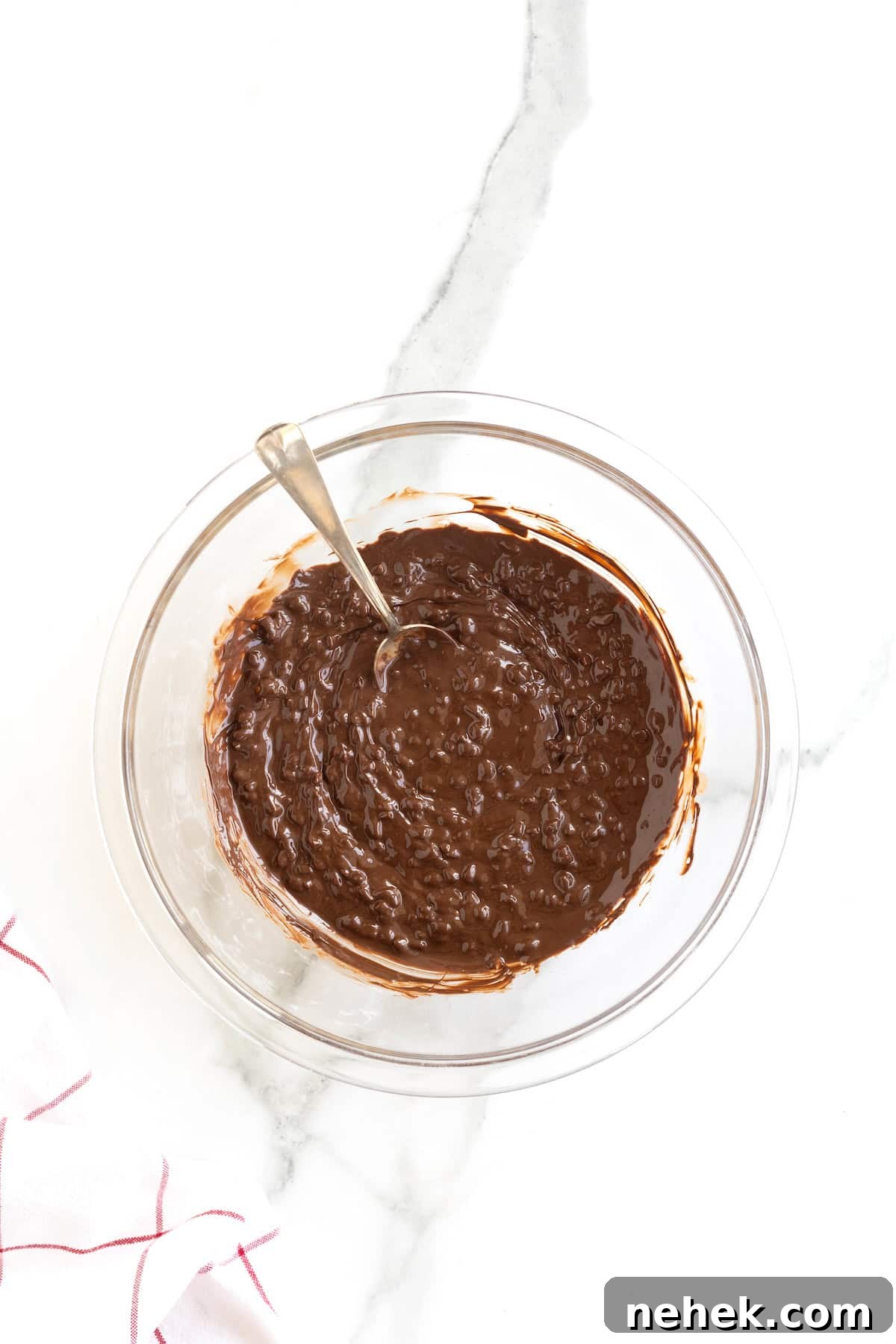 How to Make Homemade Chocolate Tacos: Step-by-Step Recipe 8 A glass mixing bowl of melted chocolate with chopped peanuts stirred in.
