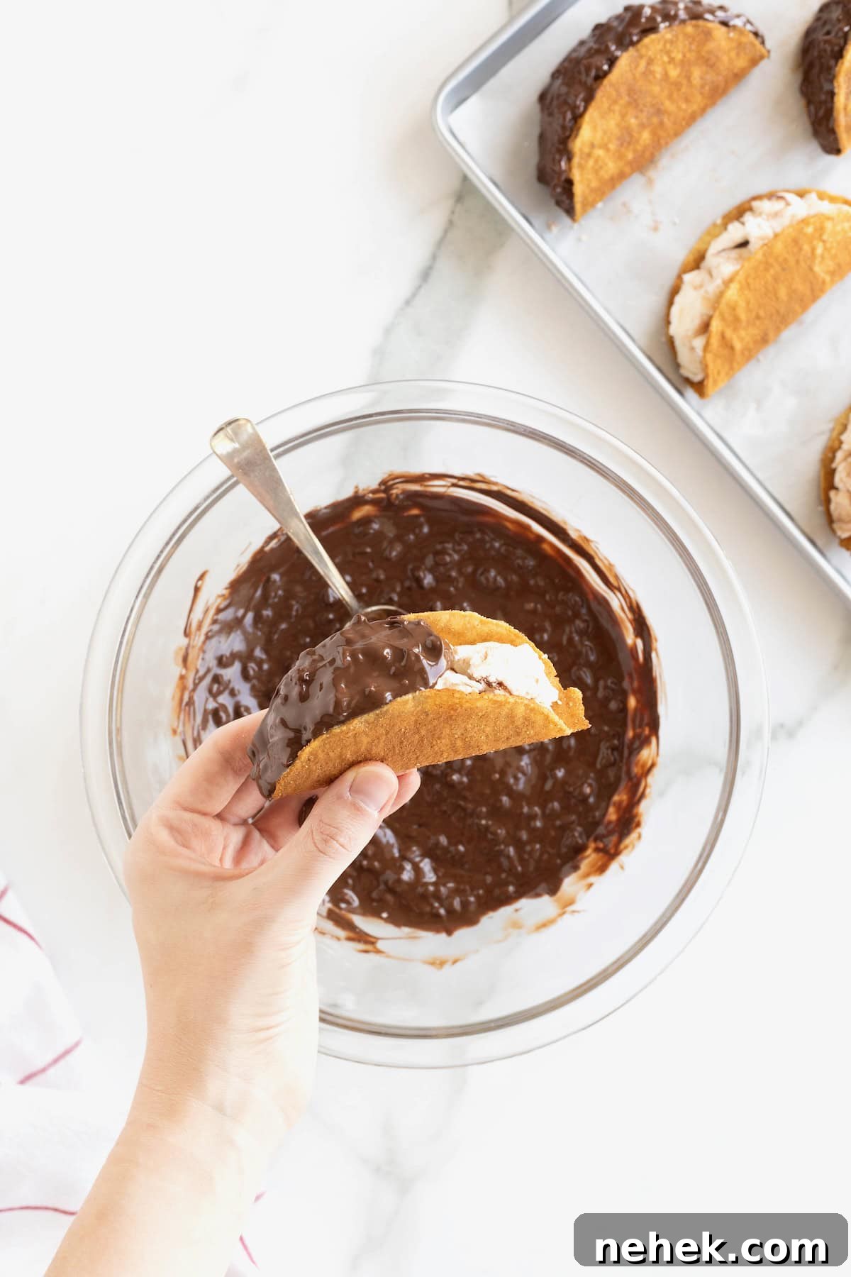 How to Make Homemade Chocolate Tacos: Step-by-Step Recipe 9 A hand holding a choco taco half coated in chocolate peanut topping.