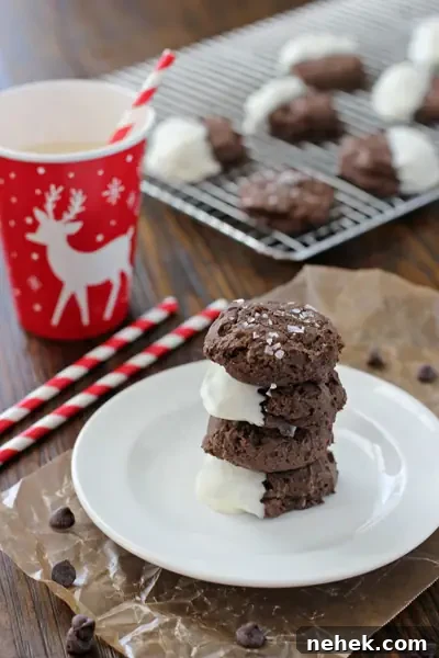 Four Chocolate Cream Cheese Cookies stacked on a white plate.
