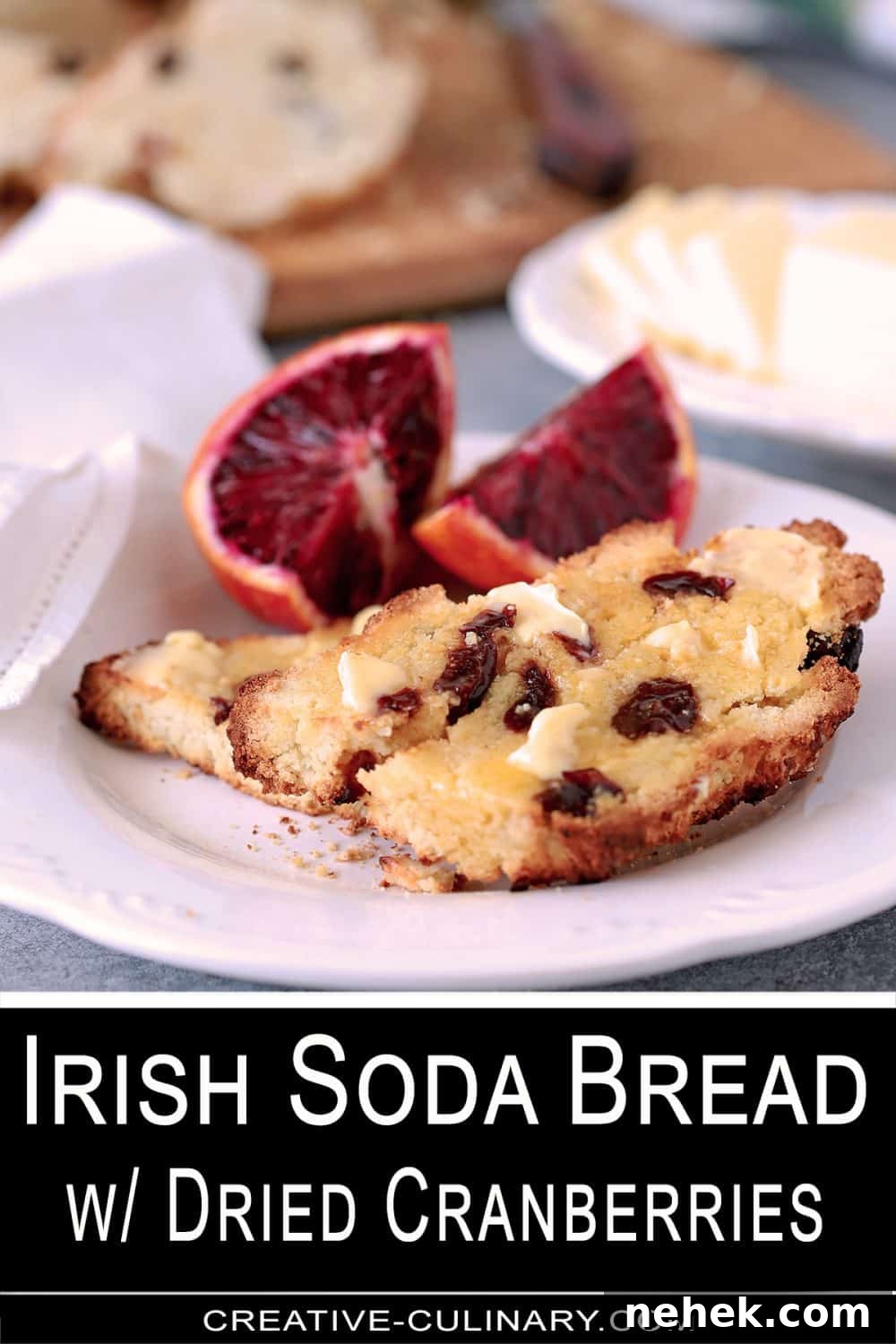 Pin for Irish Soda Bread is buttered and served on a white plate with blood orange sections.