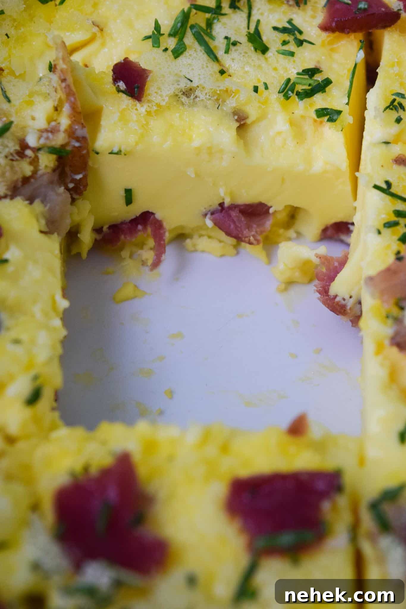 Bacon and Gruyere Breakfast Casserole Bacon and Gruyere Breakfast Casserole close up of casserole with piece missing