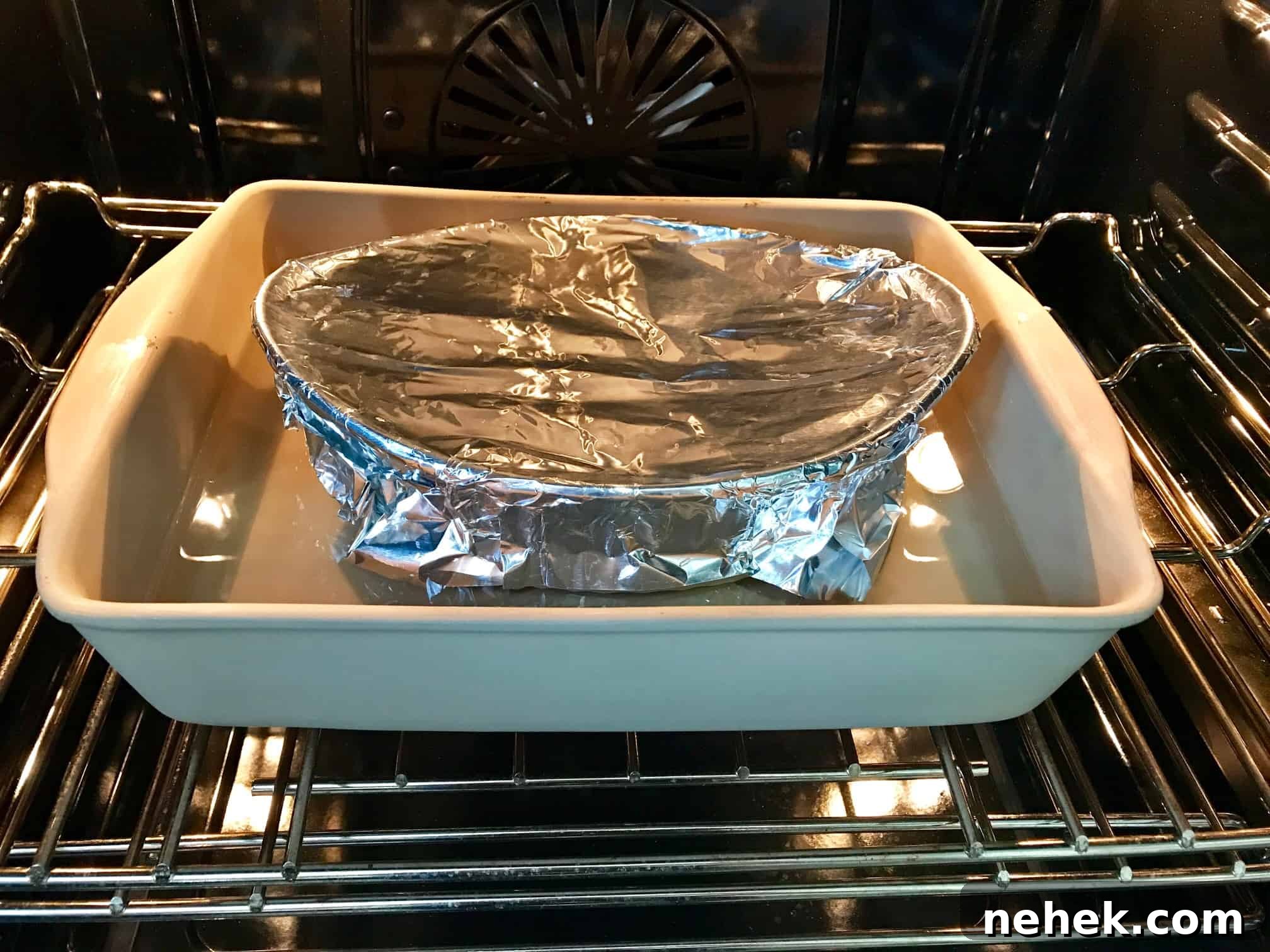 Gruyère and Bacon Breakfast Casserole Recipe for Brunch 2 Pan covered in foil in pan full of water in oven