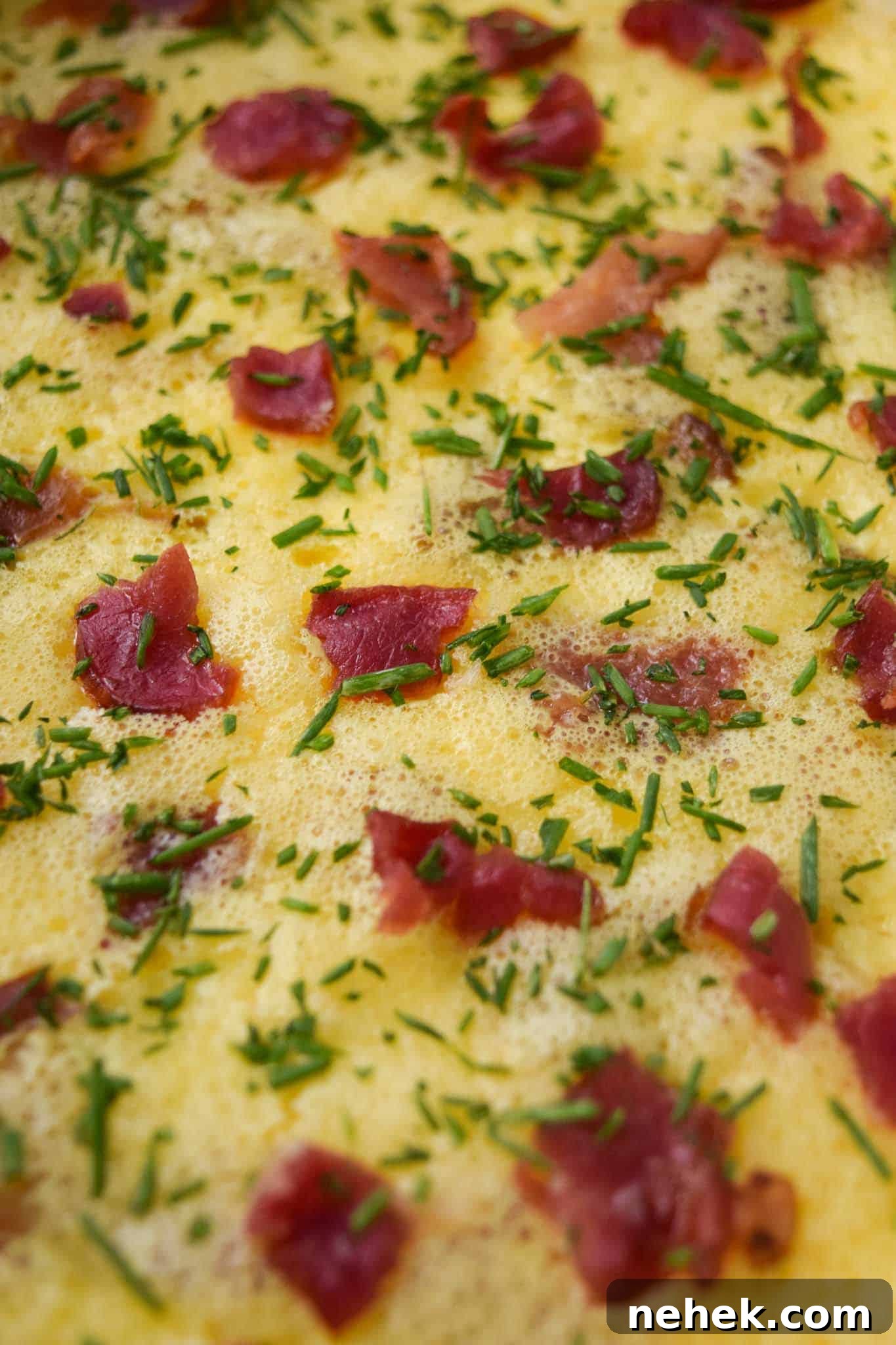 Bacon and Gruyere Breakfast Casserole Bacon and Gruyere Breakfast Casserole topped with chives close up view