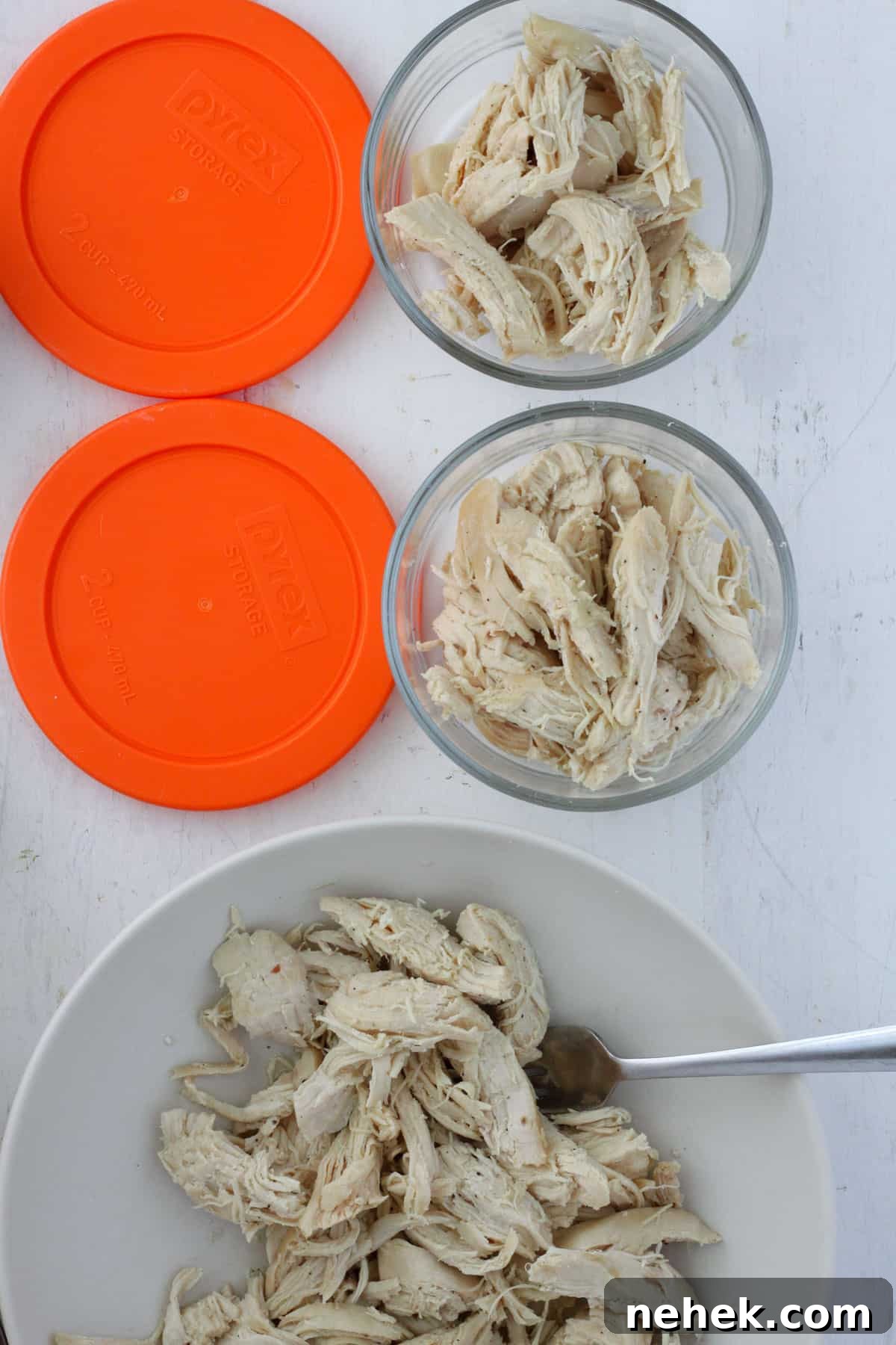 Dutch oven pulled chicken portioned into a containers for meal prep.