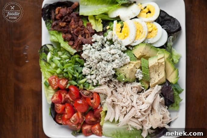 Perfect Cobb Salad has everything you want in a delicious salad including lots of greens, crisp bacon, shredded chicken, bleu cheese, hard boiled egg, ripe avocado, and tomatoes! This salad recipe is super easy to make and makes for an incredibly satisfying low carb complete meal. #cobbsalad #salad #bacon #chicken #greens #bluecheese #avocado #tomato #egg #hardboiledegg How to make Perfect Cobb Salad