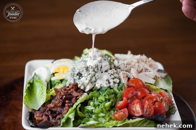 Perfect Cobb Salad has everything you want in a delicious salad including lots of greens, crisp bacon, shredded chicken, bleu cheese, hard boiled egg, ripe avocado, and tomatoes! This salad recipe is super easy to make and makes for an incredibly satisfying low carb complete meal. #cobbsalad #salad #bacon #chicken #greens #bluecheese #avocado #tomato #egg #hardboiledegg cobb salad recipe