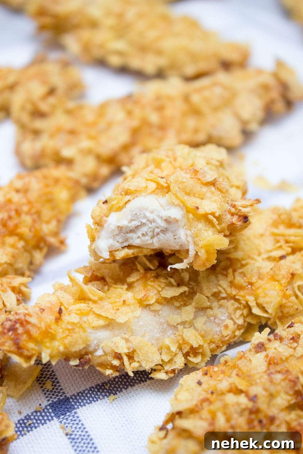 Crispy Baked Cornflake Chicken Tenders You’ll Love 7 Crispy Baked Cornflake Chicken Tenders made without added fat are the perfect low-calorie, quick and HEALTHY family meal. Served with homemade Honey Dijon Sauce, these tenders are delicious gameday finger food too. CLICK to read more or PIN for later!