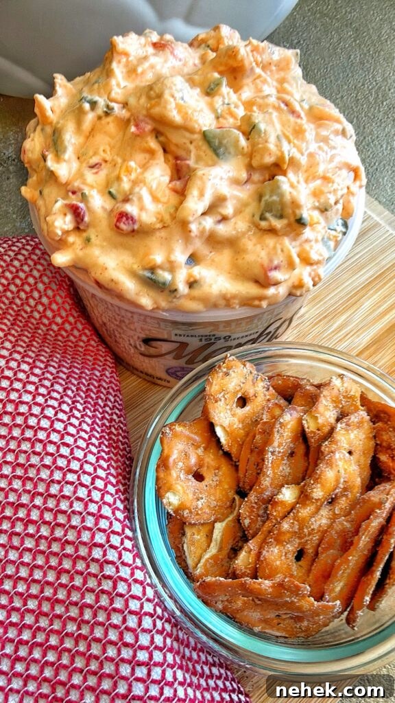 The finished Lake House Pickle Pimento Cheese dip next to pretzel crackers