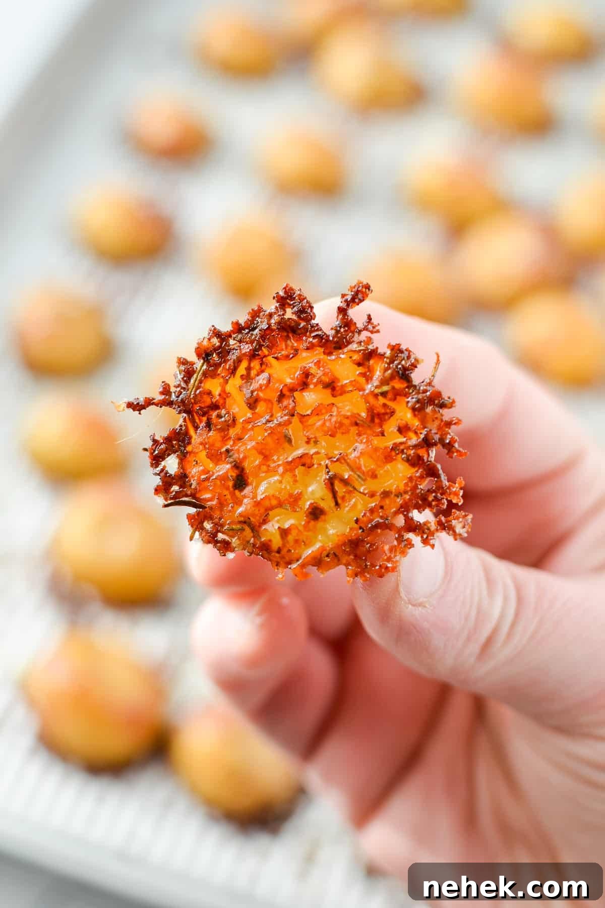 A halved baby potato encrusted with parmesan cheese.