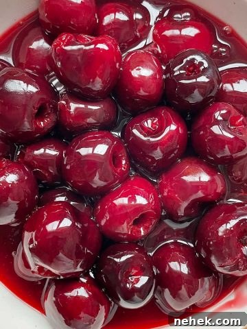 Bowl with cherry topping with syrup. Close up image.