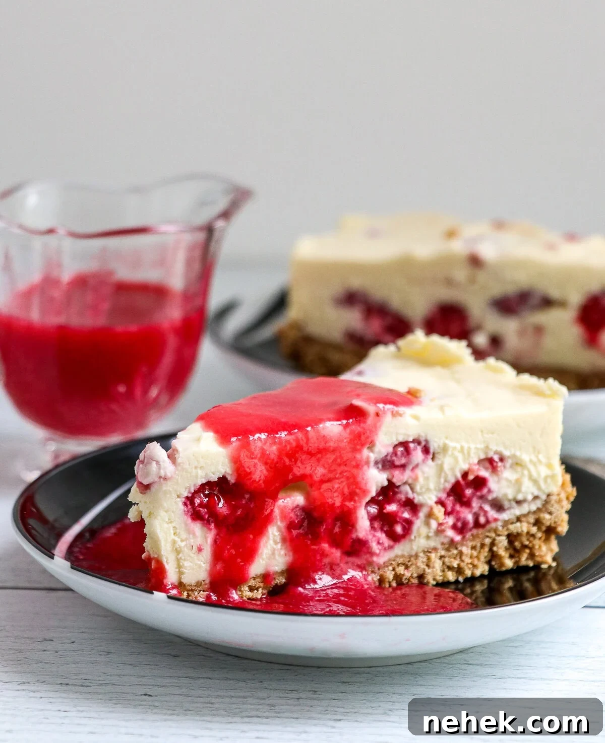 No Bake White Chocolate Raspberry Cheesecake with raspberry coulis