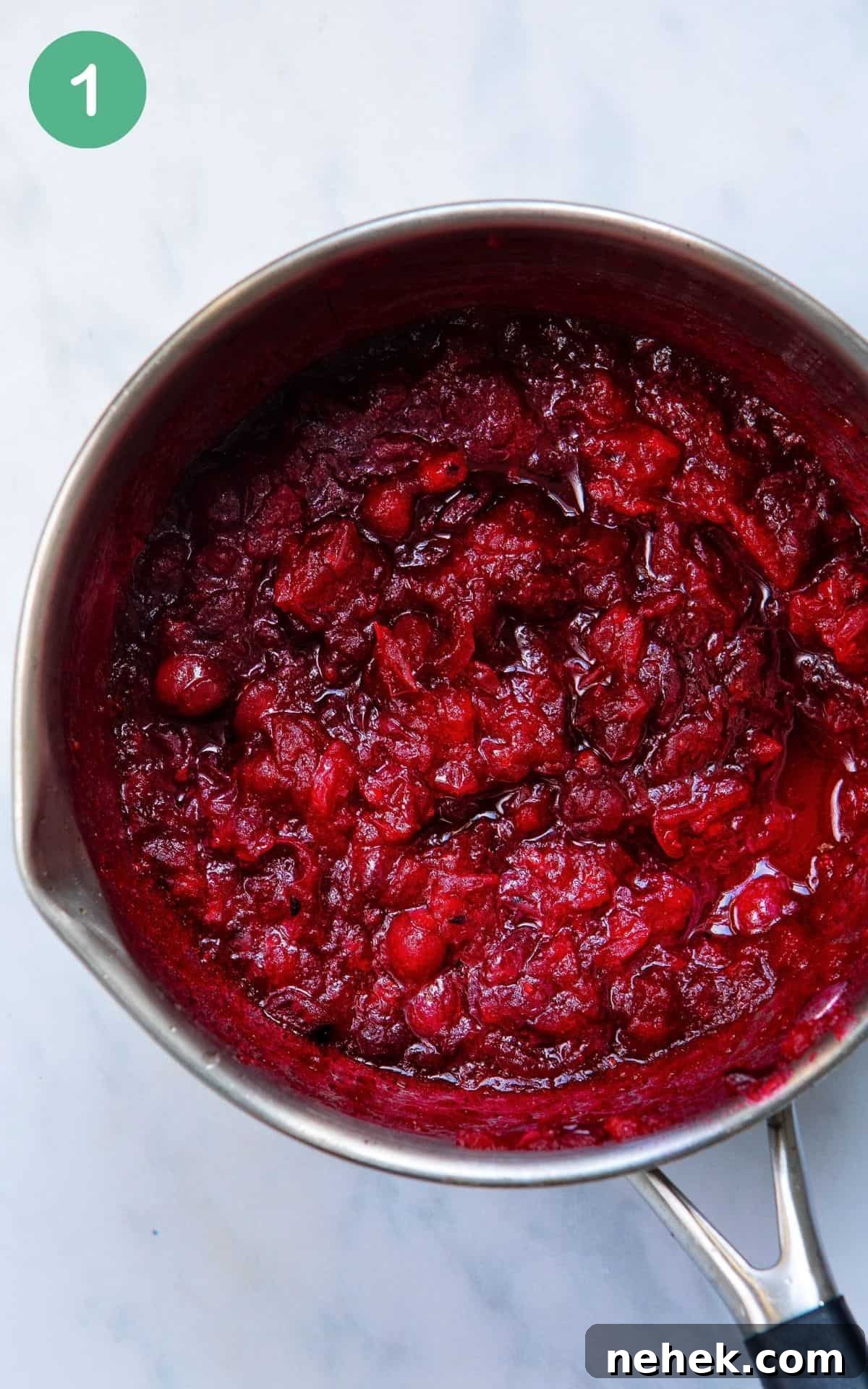 Close up image of homemade vegan cranberry sauce inside of a pot.