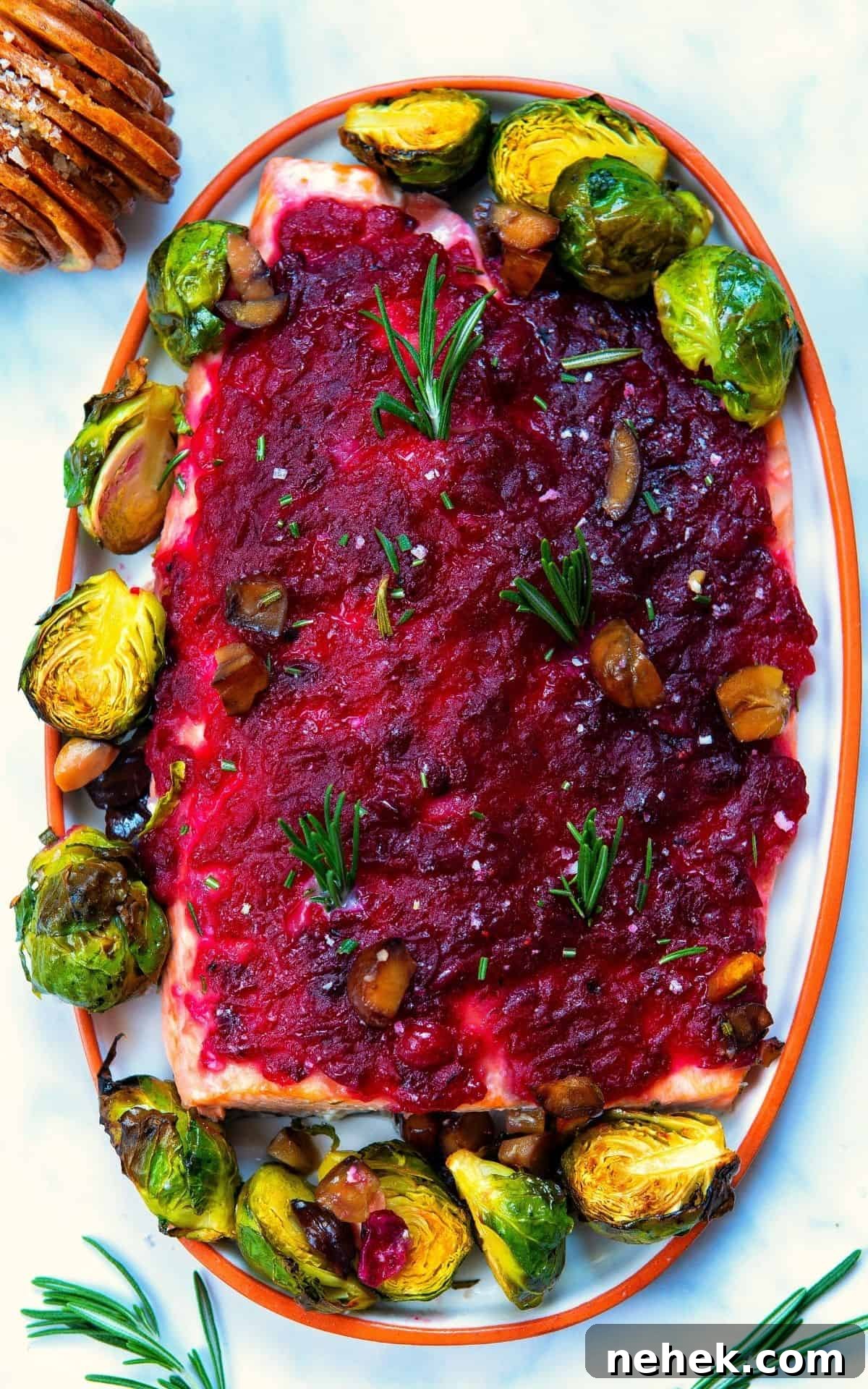 A serving platter container a cranberry sauce baked salmon.