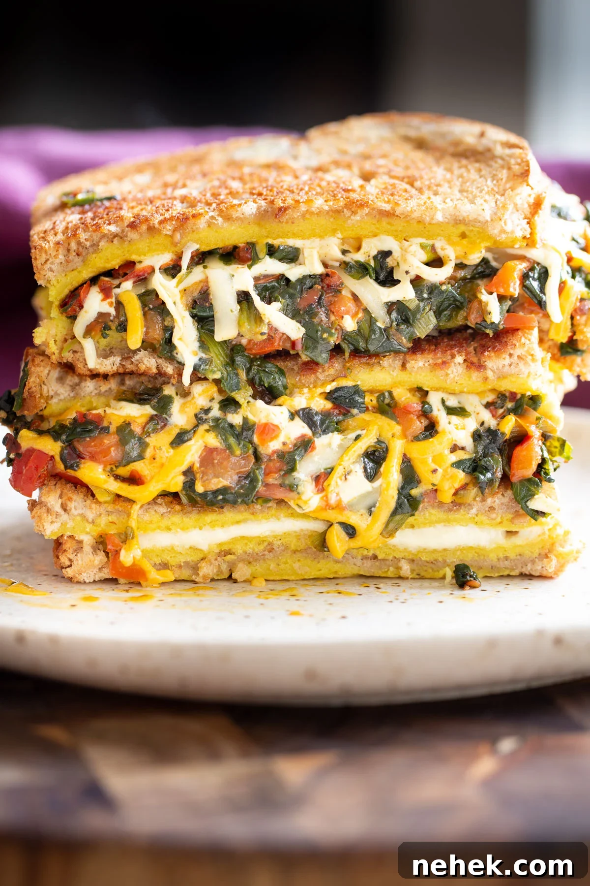Vegan Moong Egg Sandwich Recipe: Protein-Packed Plant-Based Breakfast 2 a stacked moong egg sandwich filed with spinach and cheese as well as vegetables