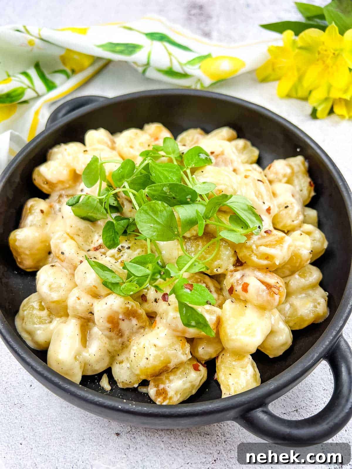 Lemon Parmesan Gnocchi with Creamy Citrus Sauce 2 Gnocchi with Lemon Parmesan Sauce in a black serving dish.