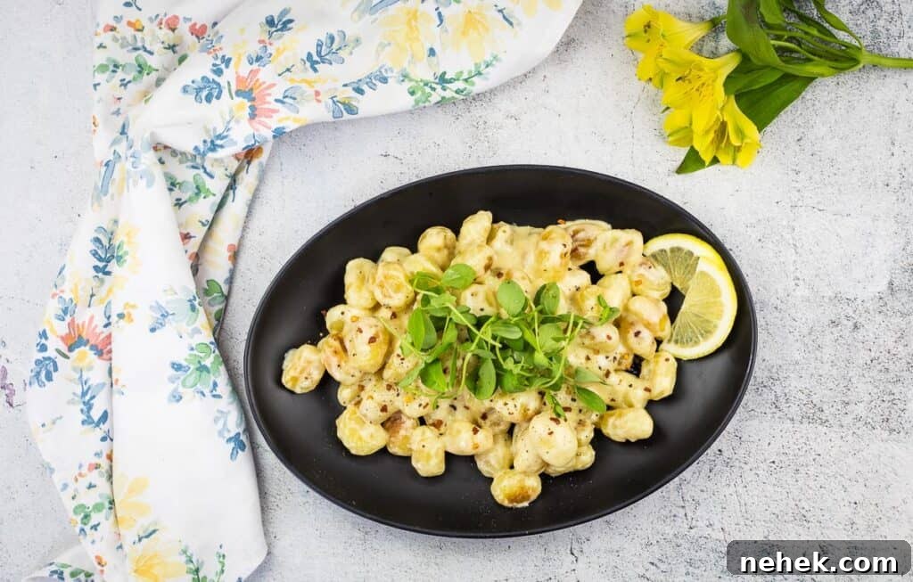 Lemon Parmesan Gnocchi with Creamy Citrus Sauce 5 A top-down shot of a plate of gnocchi with lemon sauce.