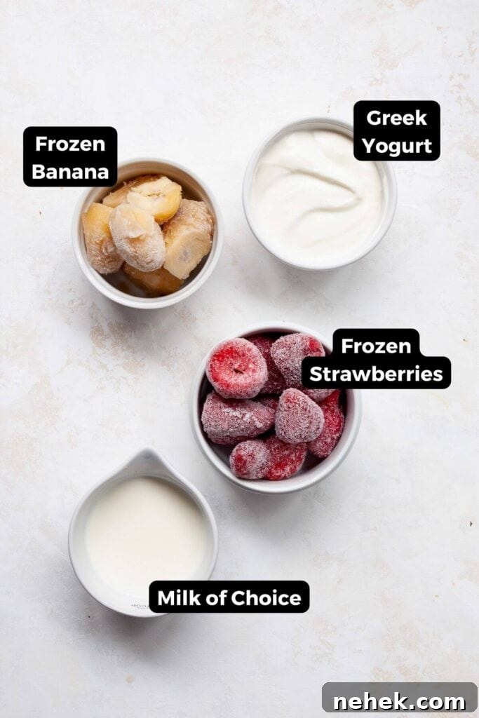 Creamy Strawberry Smoothie Bowl Recipe with Fresh Toppings 3 all ingredients in a strawberry smoothie bowl in small bowls with labels, including: greek yogurt, frozen banana, frozen strawberries, and milk